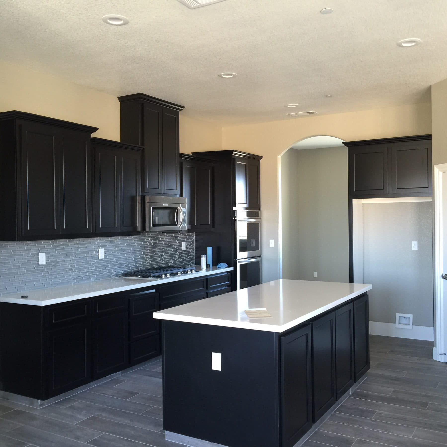 Espresso kitchen with white quartz island