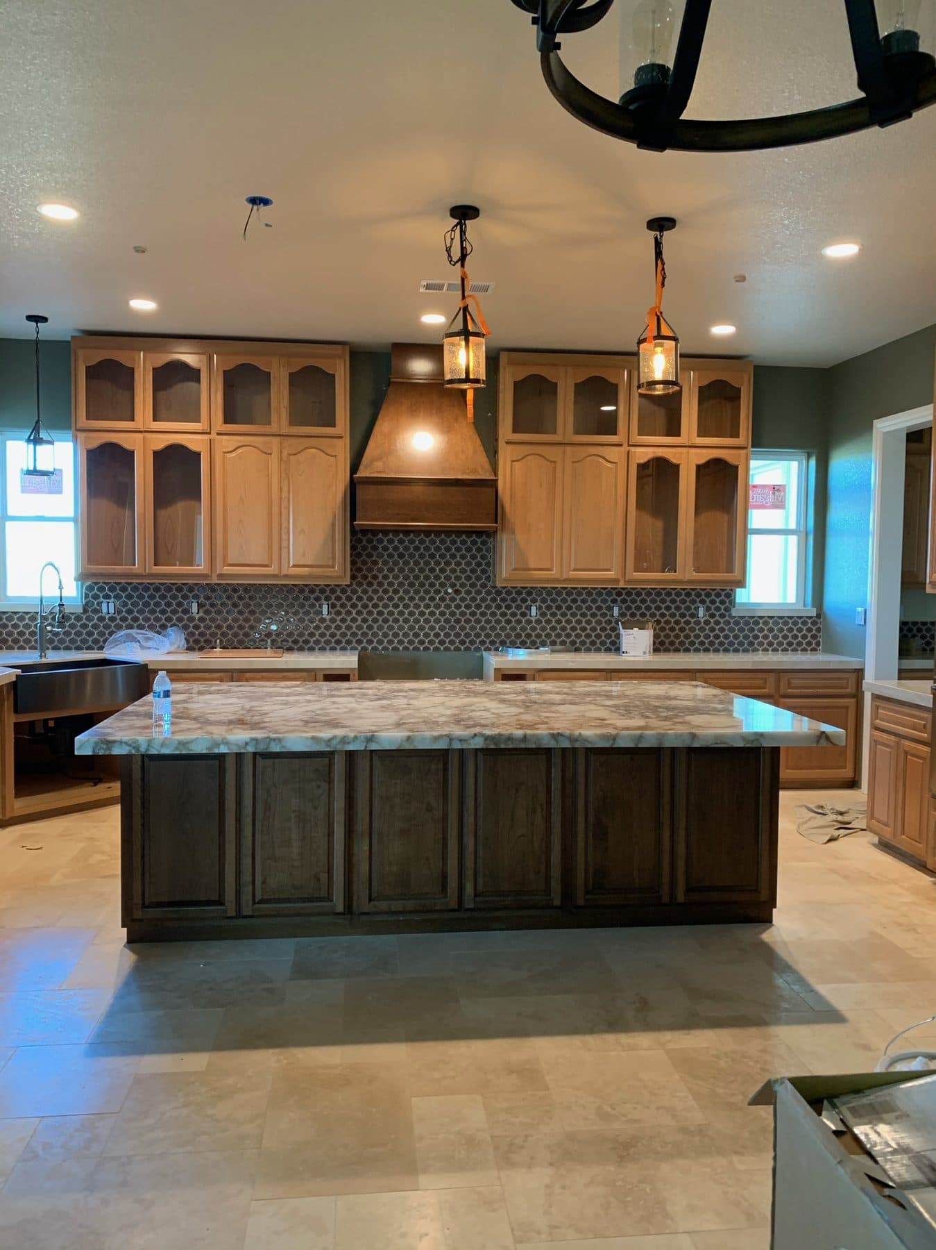 Oak kitchen with glass uppers and pendant lighting